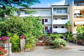 A residential building with multiple balconies, a gated entrance, and various potted plants. - SAN FRANCESCO Two-Bedroom Apartment 1 (Marija B.) (Rovinj)