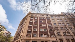 A multi-story building with a classic architectural style, featuring a symmetrical facade with evenly spaced windows and a central entrance.