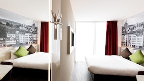 A hotel room with two beds, a view of a cityscape, and a modern design. - B&B Hotel Zürich East Wallisellen (Wallisellen)
