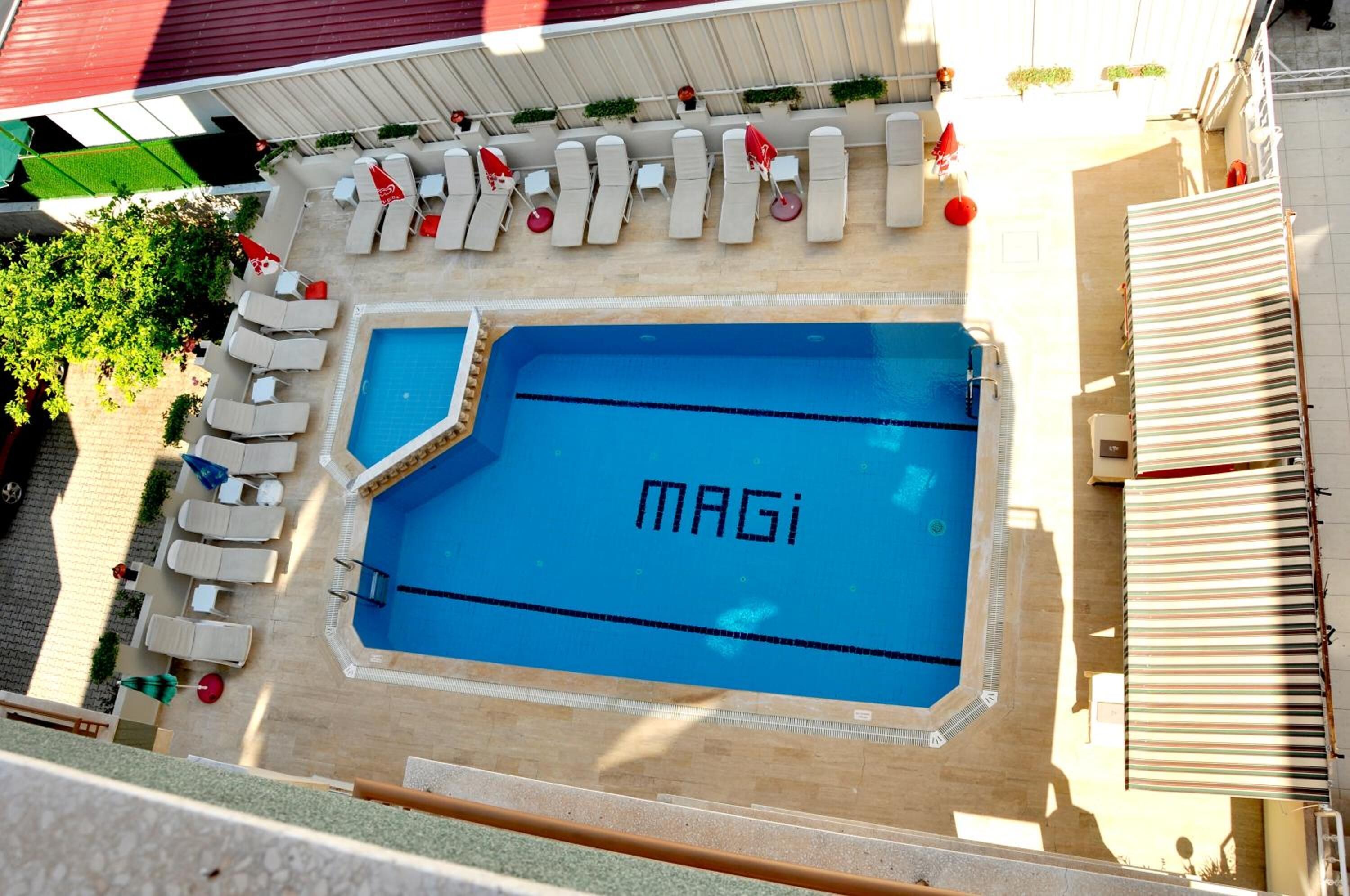 Zona piscina al terrat amb gandules i piscina amb el nom 'MAGi'.
