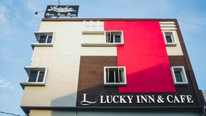 A building with a sign reading "Lucky Inn & Cafe" and a smaller sign above it that says "Lucky's." - RedDoorz Plus near Mall Panakukang 2 (Makassar)