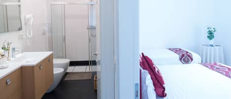 Deluxe Triple Room, Private Bathroom | In-room safe, desk, blackout drapes, soundproofing