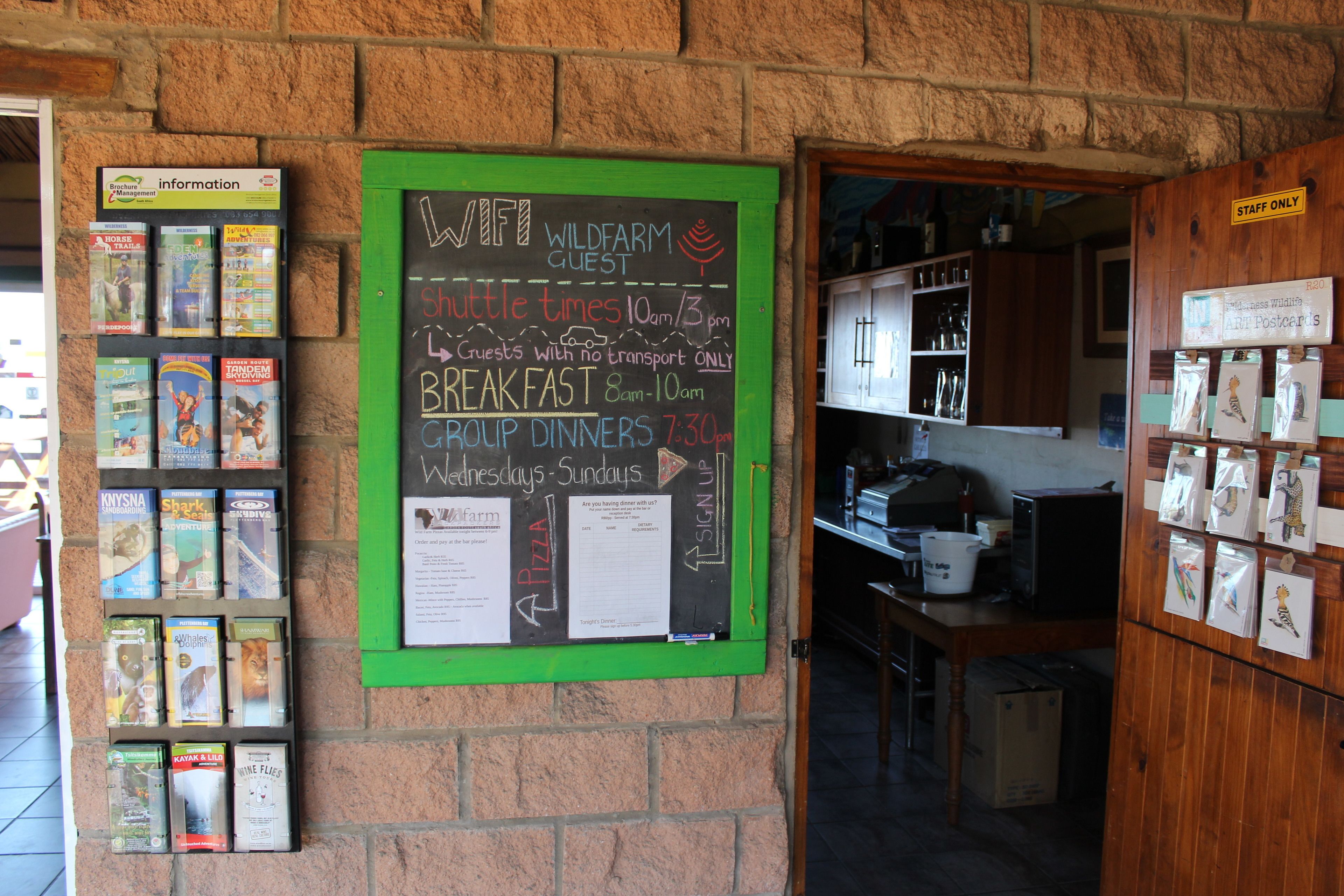 A chalkboard with information about shuttle times, breakfast, and group dinners.
