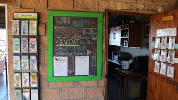 A chalkboard with information about shuttle times, breakfast, and group dinners.
