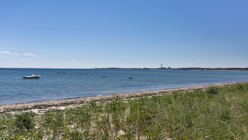 On the beach, white sand, beach umbrellas, beach towels