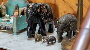 A marble countertop with decorative elephant figurines and a brass lamp.