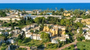 A coastal resort with villas, palm trees, and a view of the sea. - Shems Holiday Village & Aquapark (Monastir)