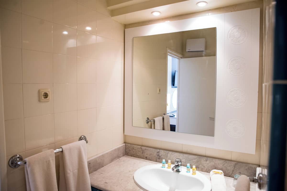 deep-soaking bathtub, rainfall showerhead, free toiletries, hair dryer