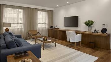A modern living room with a sofa, coffee table, and a TV.
