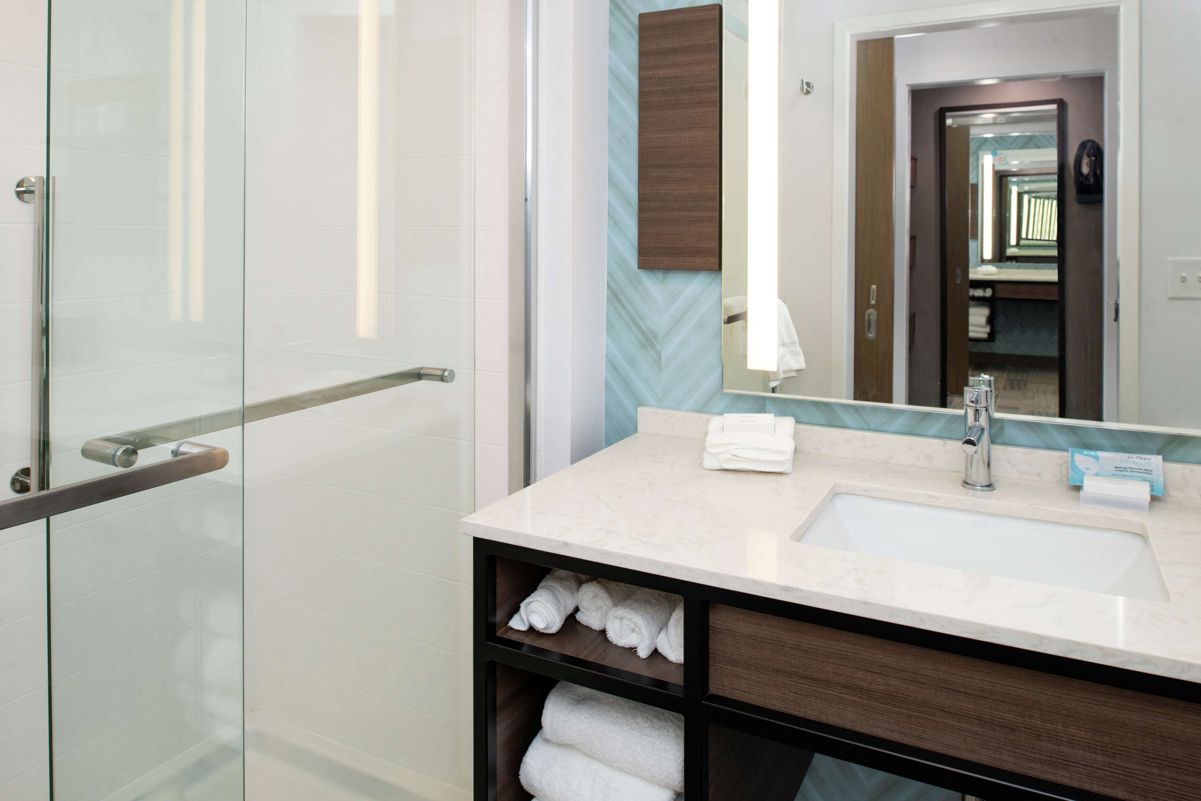 designer toiletries, hair dryer, towels, soap