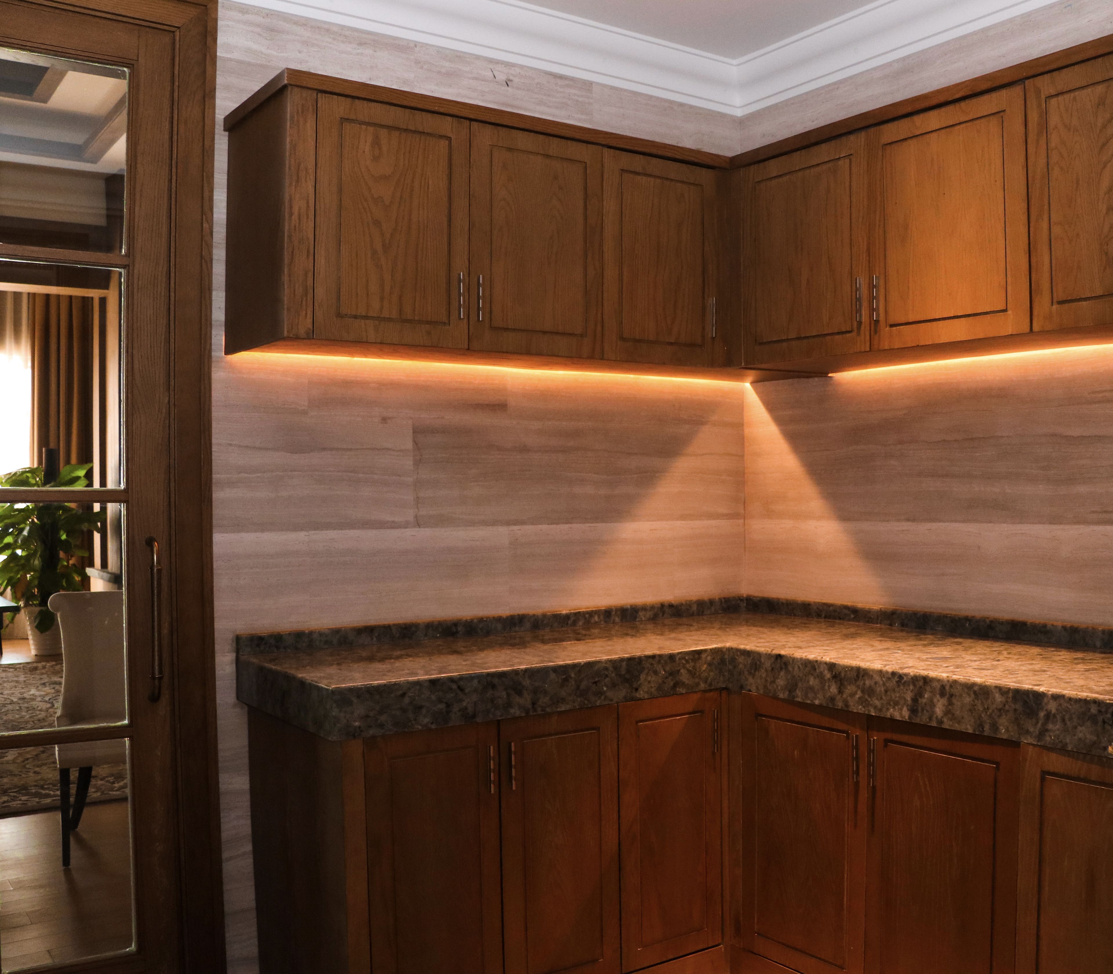 A kitchen with wooden cabinets and a granite countertop.