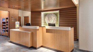 A reception area with wooden paneling and a large decorative sculpture. - Fairfield Inn & Suites by Marriott Lexington East/I-75 (Lexington)