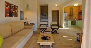 Relax in this inviting living space with a sofa, coffee table, and modern chairs.