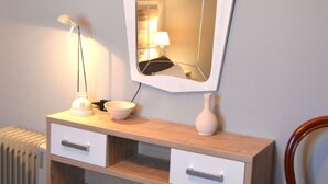 A bathroom vanity with a mirror, a lamp, a bowl, and a vase. - El Mirador de Cádiz (C��diz)
