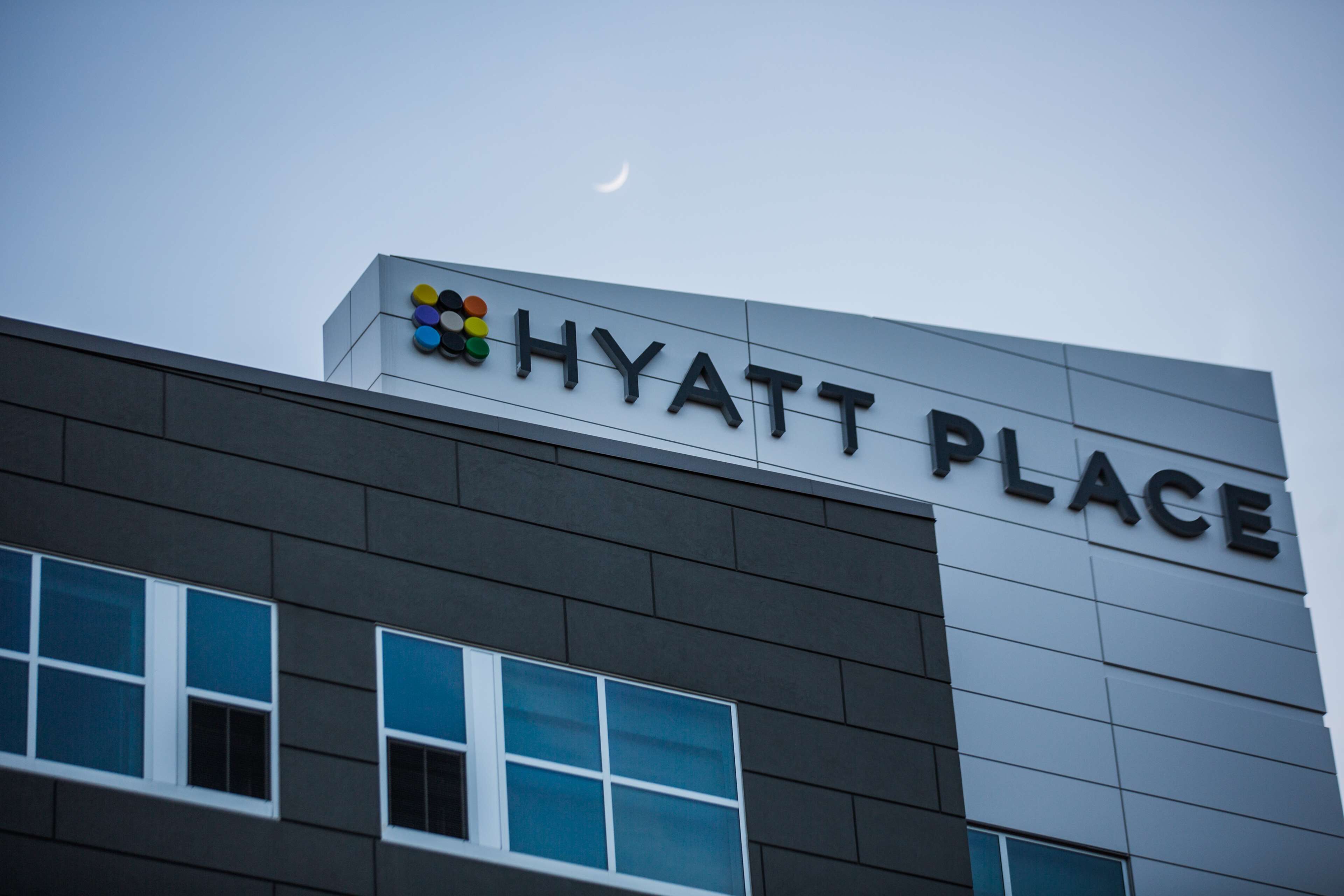 The exterior of a building with the sign "HYATT PLACE" and a logo above it.