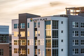 A multi-story building with a sign reading "HYATT PLACE".