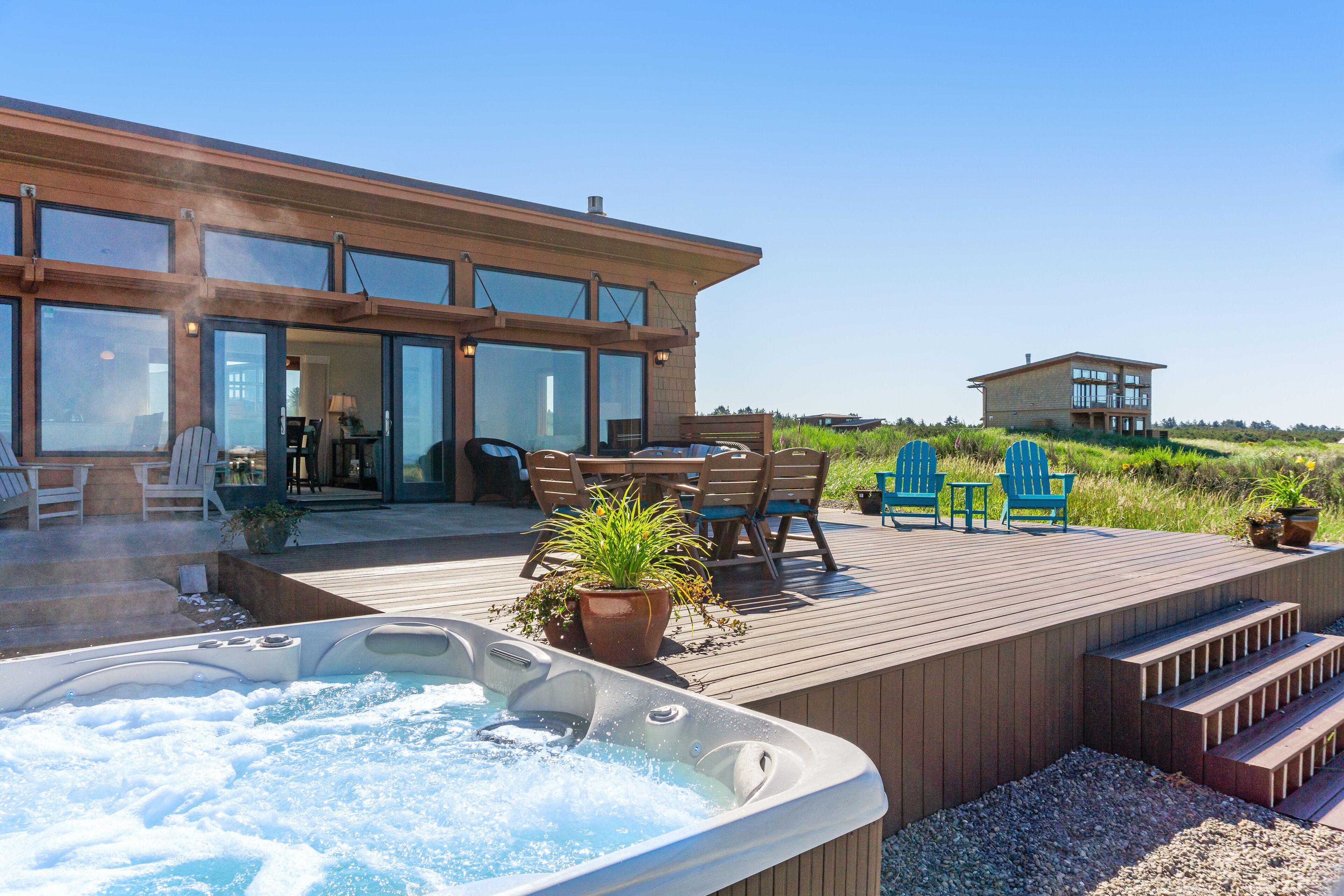 Oceanfront beach home with private hot tub, ocean views, & free WiFi