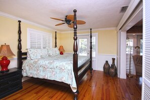 A four-poster bed with a ceiling fan, wooden flooring, and two bedside lamps. -  Private tropical paradise 155 5 ⭐️ reviews. No cleaning, pet fees. Clothing opt. (Ft Myers)