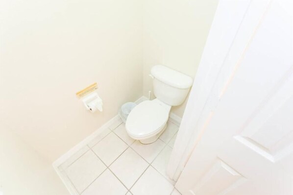 A small, clean bathroom with a toilet and a white sink. - 4BD/3B,EXECUTIVE VILLA WITH SPA,MUST SEE,10 MIN FROM DISNEY (Kissimmee)