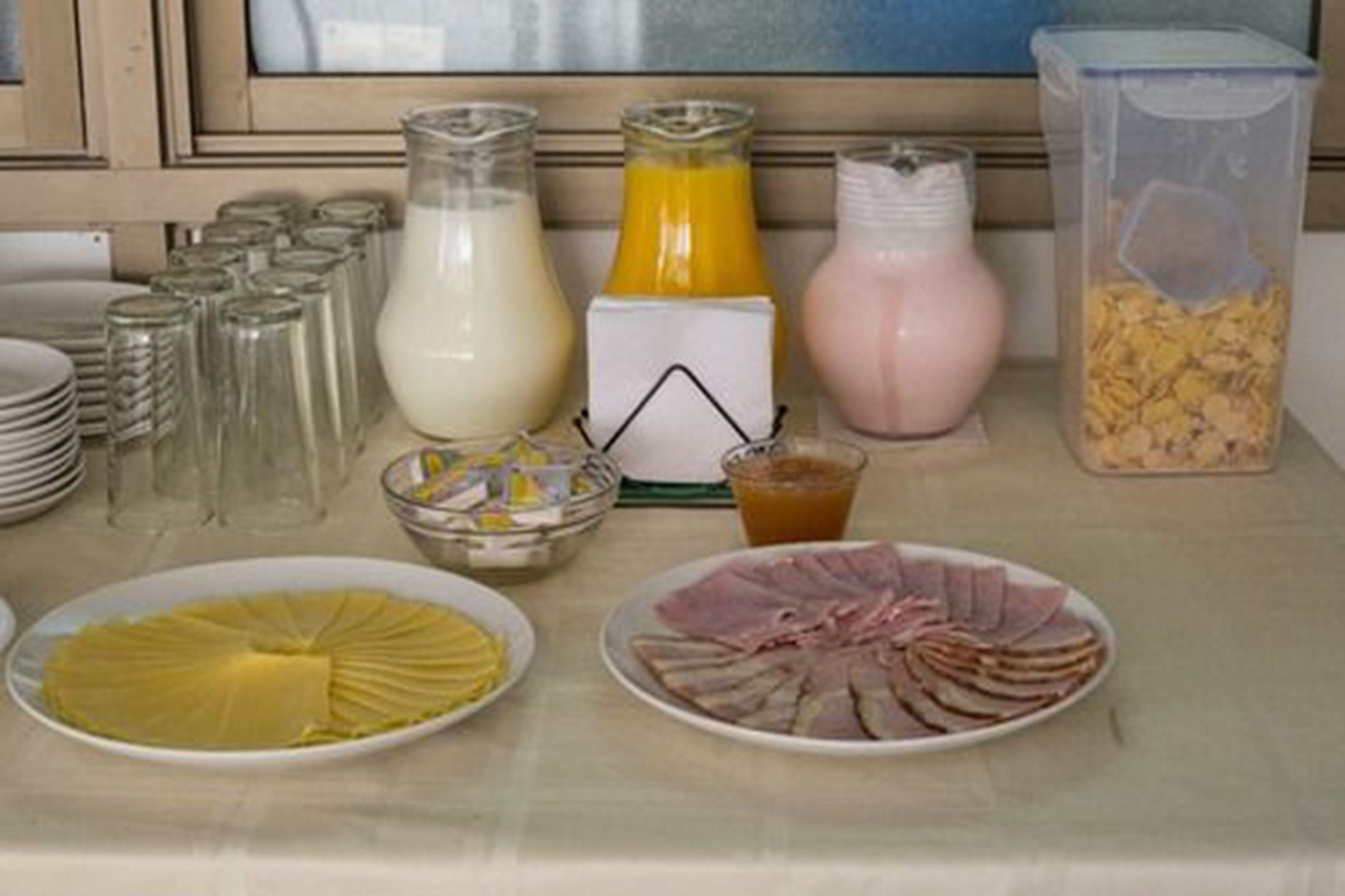 A breakfast buffet with various food items and beverages.