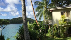 A tropical resort with a view of a calm lake and a mountain in the background. - Mala Island Resort (Mala)