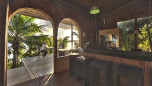An indoor bar area with a wooden ceiling, a bar counter, and seating. - Mala Island Resort (Mala)
