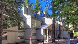 A multi-story building with a covered porch and large windows.