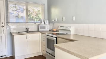 Apartment, 2 Bedrooms, Private Bathroom | Private kitchen | Full-sized fridge, microwave, stovetop, cookware/dishes/utensils
