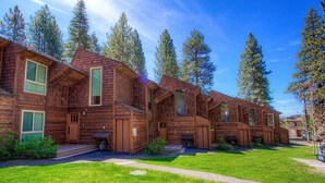 A row of wooden cabins with large windows and a grassy lawn. - Beachside Bungalo | Deck | BBQ (Kings Beach)