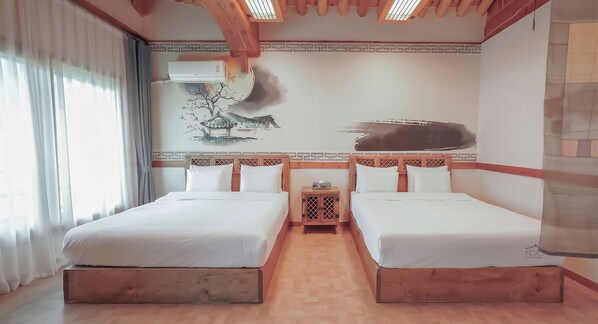 A hotel room with two beds, a wooden headboard, a nightstand, and a wall with a painting. - Jeonju Wangyijimil Hanok Hotel (Jeonju)