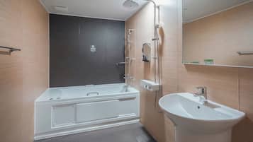 A modern bathroom with a bathtub, a sink, and a shower.