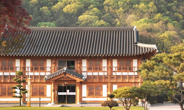 A traditional wooden building with a tiled roof and a wooden entrance.