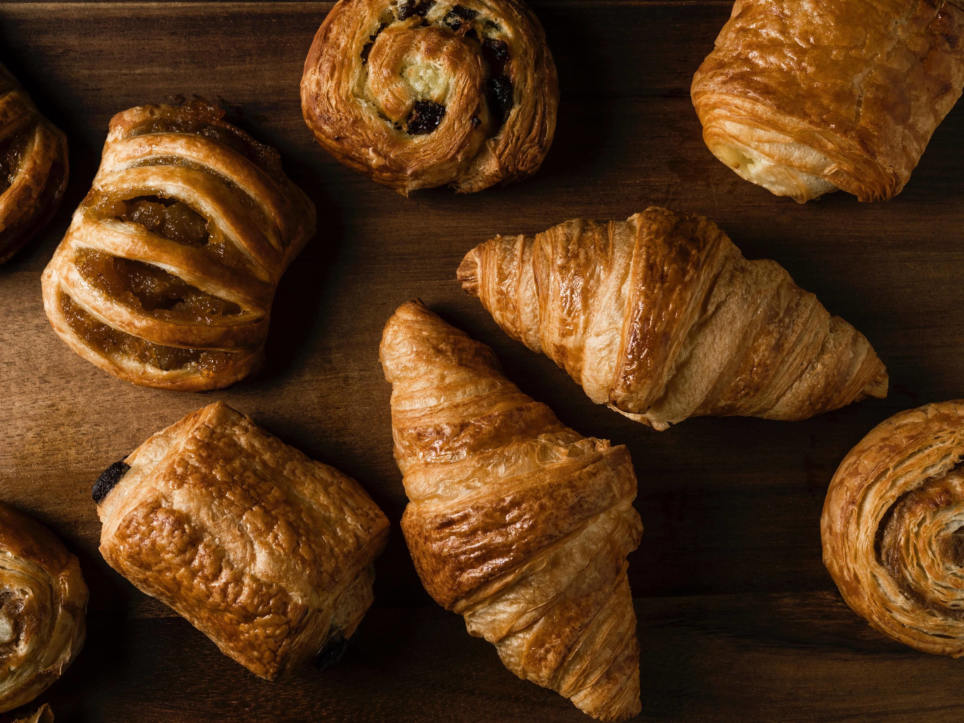 A variety of pastries on a wooden surface.