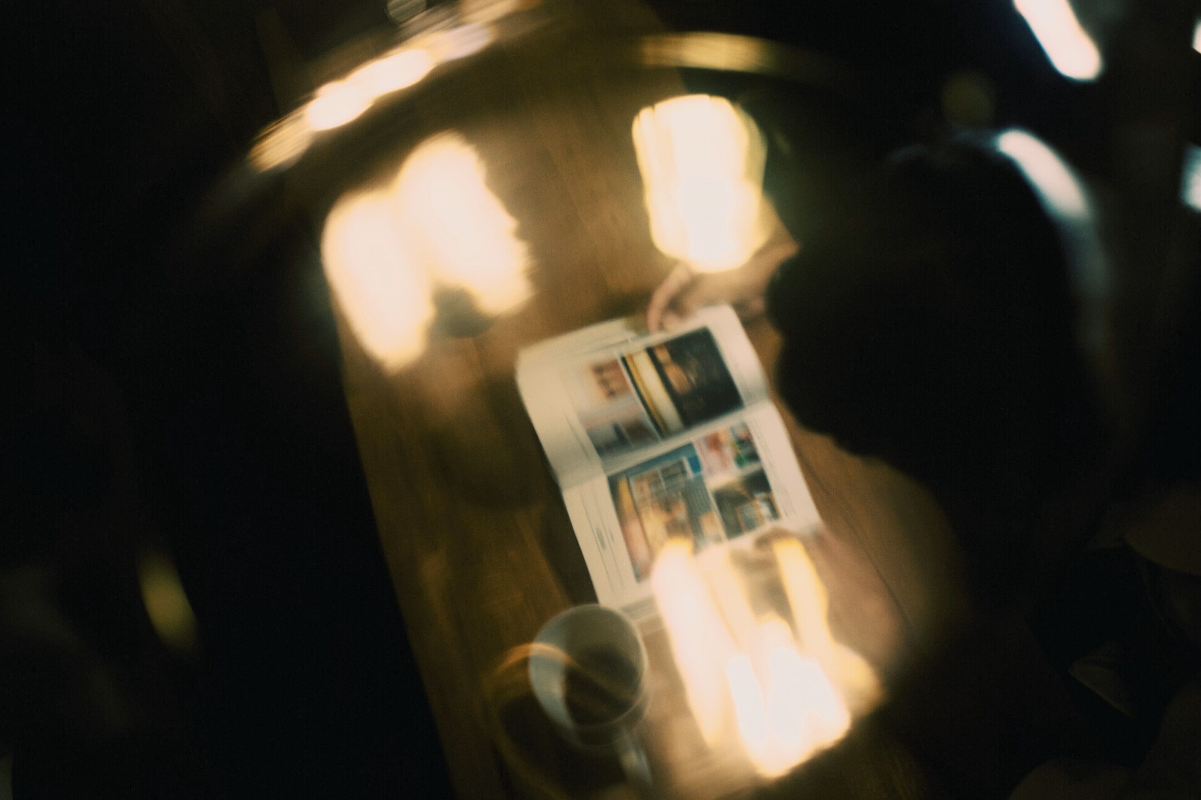 A close-up of a wooden surface with a magazine or brochure.