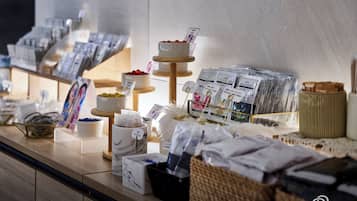 A buffet area with various food items and packaged goods.