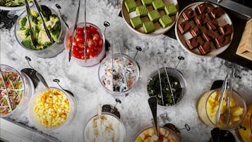 A variety of food items displayed on a marble surface with ice.