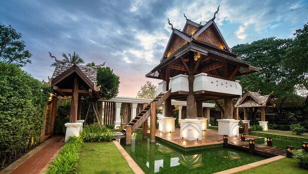 A traditional wooden structure with a tiled pool in front. - Shinnabhura Historic Boutique hotel (Phitsanulok)
