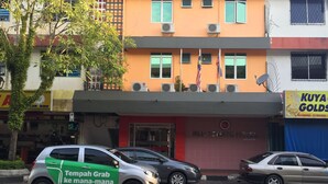 A building with a red storefront labeled "RED TOMATO HOUSE".