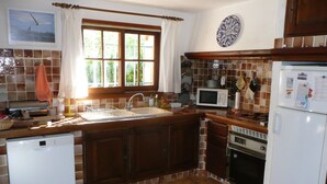 A kitchen with a sink, microwave, stove, and dishwasher. - PROVENCE: HOUSE IN LES SALLES/VERDON, 400 M FROM LAC DE SAINTE-CROIX, GORGES DE L'OUEST (Les Salles-Sur-Verdon)