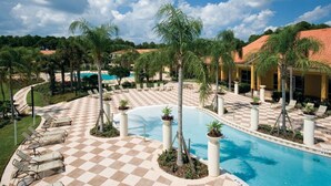 A pool area with checkered flooring, lounge chairs, palm trees, and a clear blue sky. - 3Bed ★ 2.5Bath ★ Gated Resort ★ Private & Clubhouse Pools ★ 5 Miles to Disney (Kissimmee)