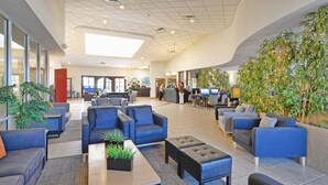 A spacious lobby with seating areas, a reception desk, and a large indoor plant wall. - 3Bed ★ 2.5Bath ★ Gated Resort ★ Private & Clubhouse Pools ★ 5 Miles to Disney (Kissimmee)