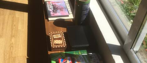 A table with various board games and a box of UNO cards.