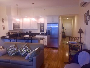 A compact living space with a kitchenette, a sofa, and a dining area.