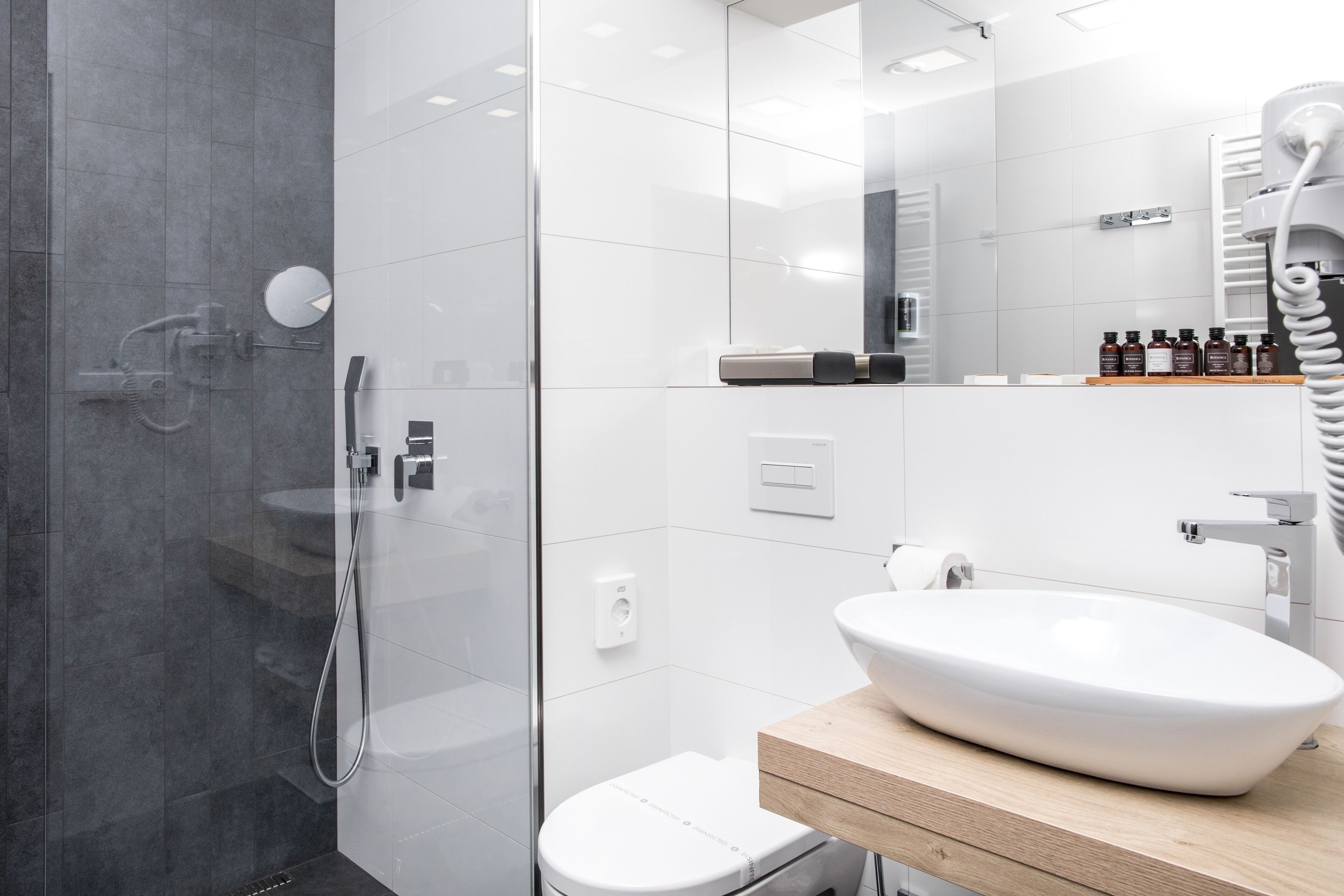 designer toiletries, hair dryer, slippers, towels