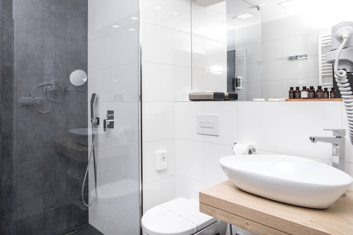 designer toiletries, hair dryer, slippers, towels