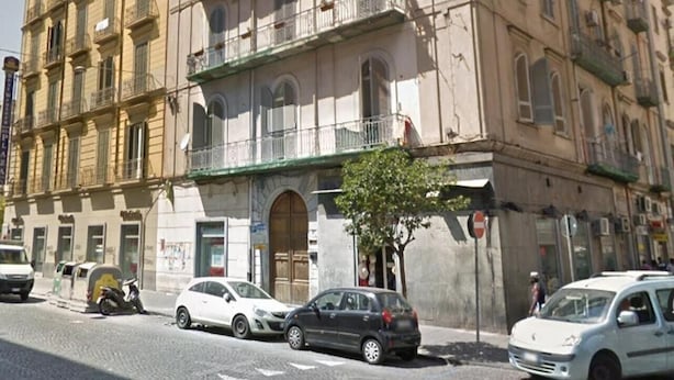 A multi-story building with balconies, a green awning, and a tree in front. - Naples to live (Naples)