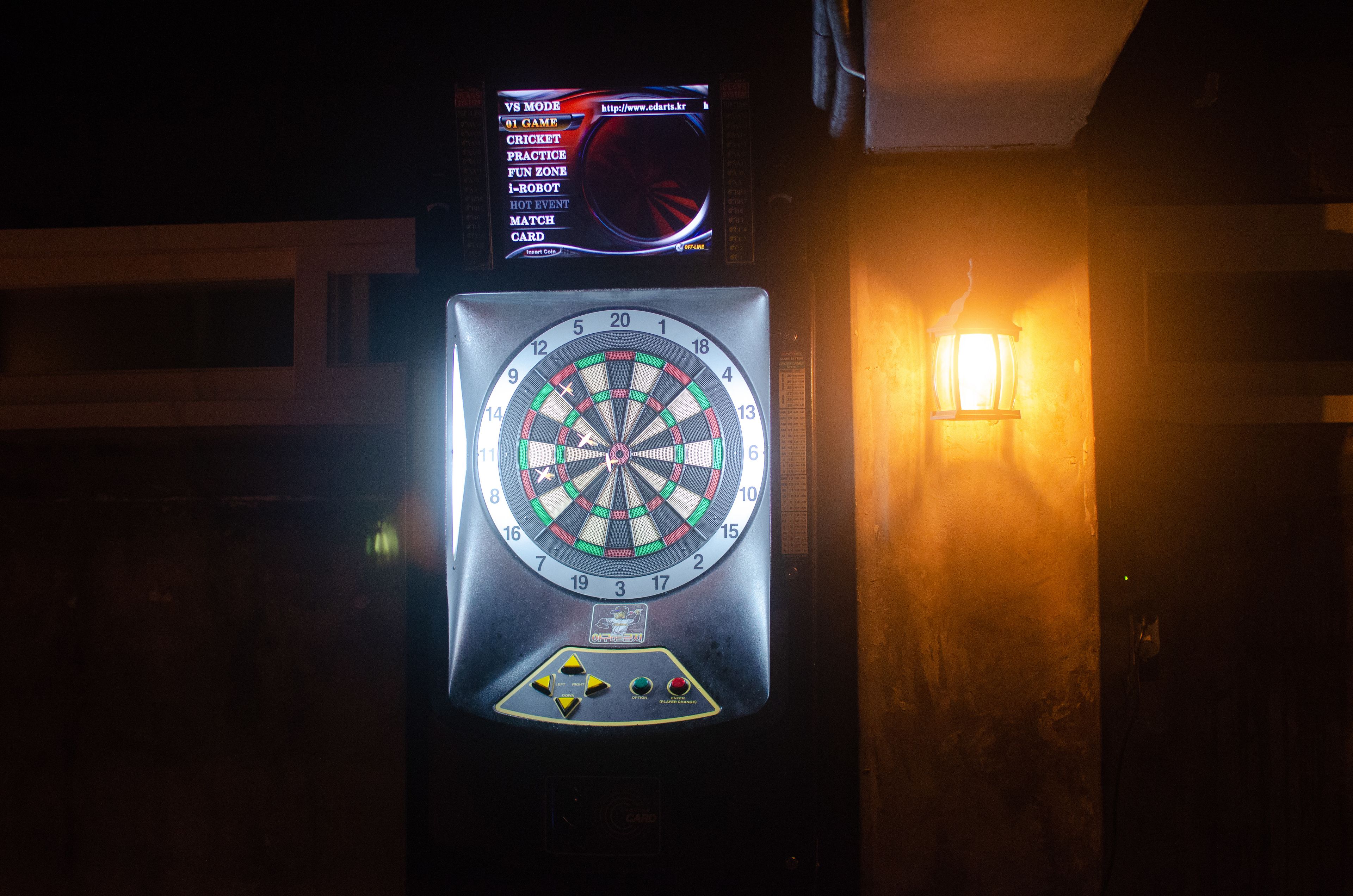 A dartboard with a digital scoreboard above it.