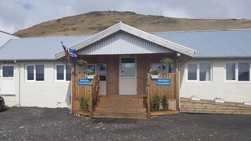 A reception area with a wooden entrance, two signs reading "Möttaka Reception," and a flag.