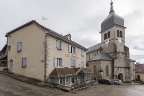 A building with a sign reading "La Carmine" and a clock tower.