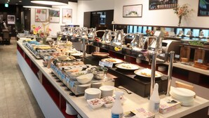 A buffet setup with various food items and condiments, arranged on a long counter with multiple serving stations. - Kyoto Yamashina Hotel Sanraku (Kyoto)